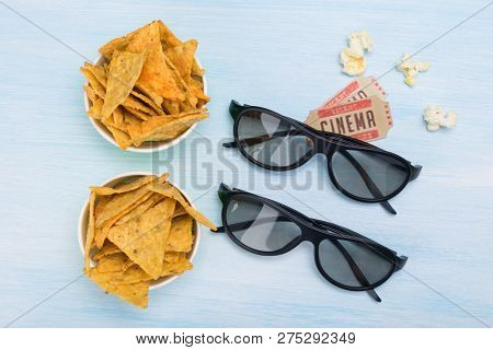 Two Cinema Tickets, A Paper Cup With Nachos And 3 D Glasses For Watching A Movie On A Light Backgrou