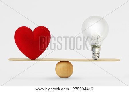 Heart And Light Bulb On Scale - Concept Of Balance Between Heart And Brain