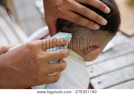 Father Cuts Machine Child At Home. For Any Purpose. Concept Of Father And Son