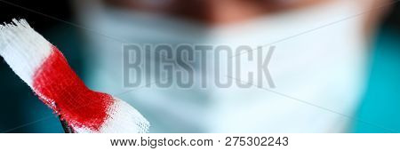 Surgeon In Sterile Uniform Arms Holding And Passing To Colleague Tools With Bio Material Wad Closeup