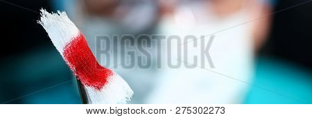 Surgeon In Sterile Uniform Arms Holding And Passing To Colleague Tools With Bio Material Wad Closeup