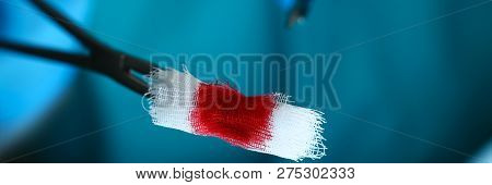Surgeon In Sterile Uniform Arms Holding And Passing To Colleague Tools With Bio Material Wad Closeup