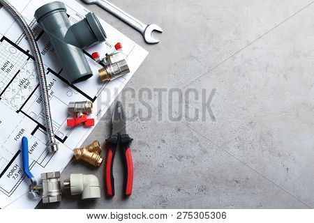 Flat Lay Composition With Plumber's Tools And Space For Text On Grey Background
