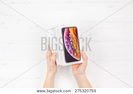 Berlin, Germany - December 09, 2018: Woman Hands Holding The Colorful Box Of The Latest Apple Iphone