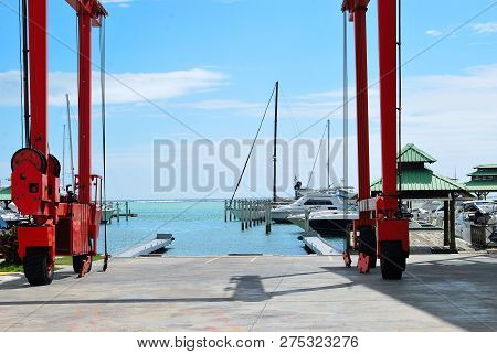 Crane For Lifting Boats And Yachts At Pier. Carribian Sea Gate.