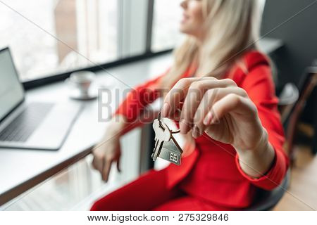 Mortgage Concept. Woman In Red Coral Business Suit Holding Key With House Shaped Keychain. Modern Li
