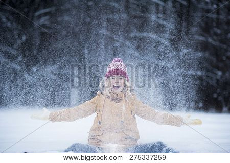 Very Beautiful Bright Young Girl In A Red Hat And Yellow Mittens On The Background Of A Winter Park