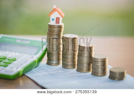 Mini House On Stack Of Coins,money And House,  Mortgage, Savings Money For Buy House And Loan To Bus