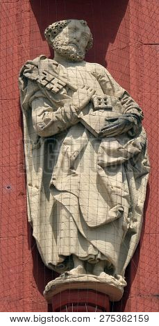 WURZBURG, GERMANY - JULY O4, 2018: Saint Peter the Apostle statue on the portal of the Marienkapelle in Wurzburg, Bavaria, Germany