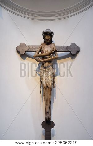 WURZBURG, GERMANY - JULY O4, 2018: Schmerzensmannkreuz, Jesus on the cross, his arms crossed like a gesture of embrace, Neumunster Collegiate Church in Wurzburg, Germany