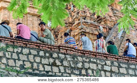 Jule 5, 2018. Nha Trang. Vietnam. Temple Complex. Thap Ba Ponagar. Tourists Are Sitting On A Stone W