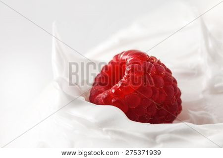 Sweet Raspberry In Yogurt. Close-up Milk Or Cheese Dessert With Raspberry. One Fresh Raspberry On A 