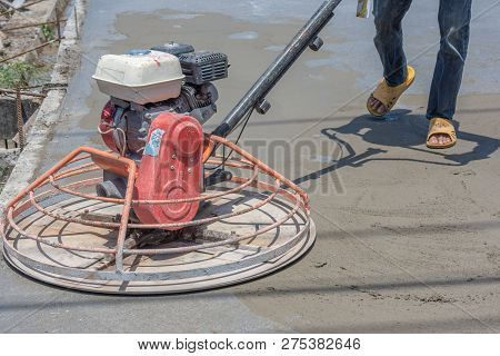 Workers Are Using Concrete Polishing Machines For Cement After Pouring Ready-mixed Concrete On Steel