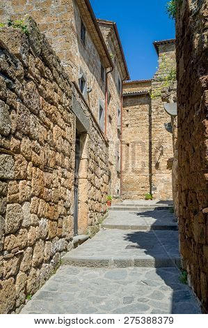 Vertica Photo Of Civita Di Bagnoregio Old Town Narrow Street. Tuscany, Italy.
