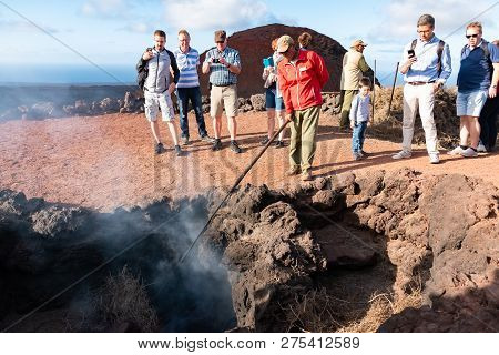 Lanzarote, Spain - Dec 13 2018: Tourists Watching Artificial Volcanic Fire In Timanfaya National Par