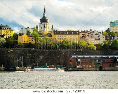 Beautiful Buildings Of Stockholm Sweden And The Tourist Boat Sailing On The Lake.