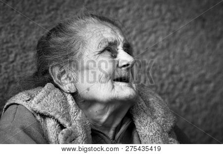 Very Old And Tired Wrinkled Woman Outdoors