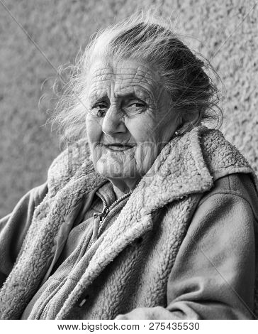 Very Old And Tired Wrinkled Woman Outdoors