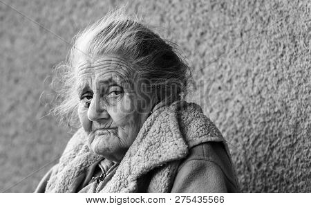 Very Old And Tired Wrinkled Woman Outdoors