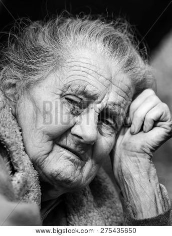 Very Old And Tired Wrinkled Woman Outdoors