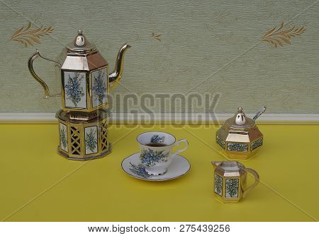English Teacup, Saucer, Silver-plated Teapot On A Silver Stove, Cream Jug, Sugar Bowl And Sugarspoon