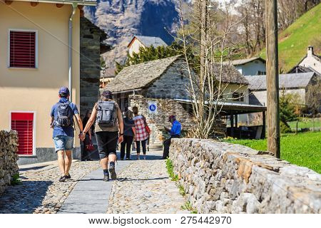 Sonogno, Switzerland - 21 April 2018 - Unidentified Tourists Walk On Typical Alleys Through Sonogno 