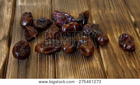 Dried Dates Lie On A Wooden Table. High-calorie Foods.