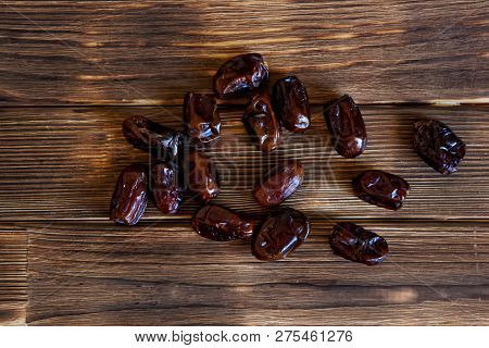 Dried Dates Lie On A Wooden Table. View From Above. High-calorie Foods.