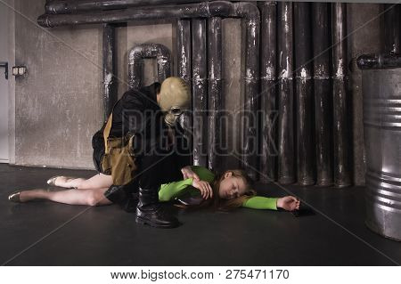 A Man In A Gas Mask Carries Away A Suffocated Girl