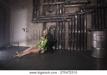 A Man In A Gas Mask Carries Away A Suffocated Girl