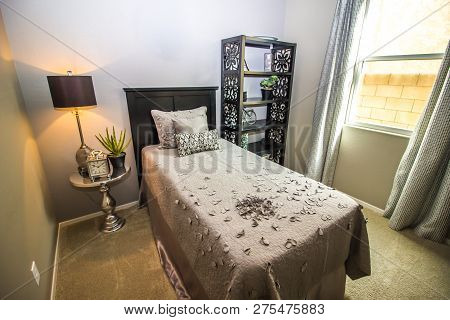 Modern Bedroom With Bed, Lamp, Night Table And Bookcase