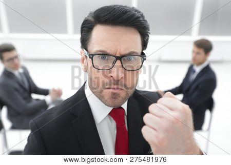 close up.angry boss showing his fist