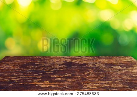 Selective Focus Of Empty Old Wood On Blur Nature Green Leaf With Bokeh.