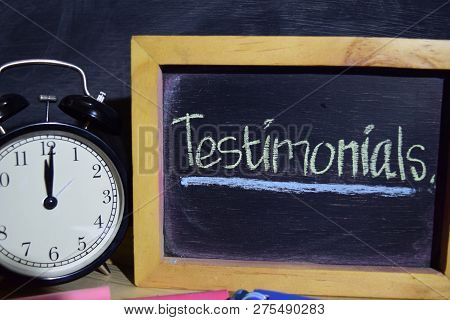 Testimonials On Phrase Colorful Handwritten On Blackboard. Education And Business Concept. Alarm Clo