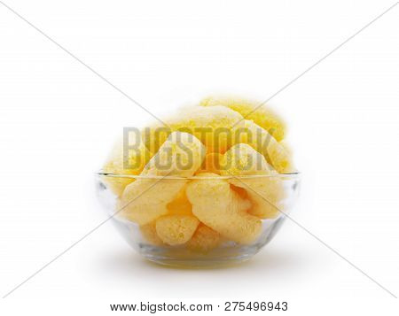 Yellow Corn Puffs In A Glass Bowl Isolated On White Background. Crunchy Flavored Puffed Snacks. Part