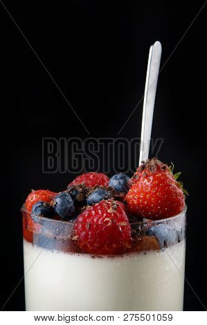 Panakota Creamy Italian Dessert In A Glass Cup With Berries And Chocolate Chips On Top