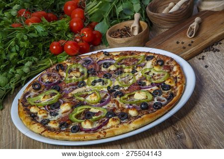 Delicious Pizza, Glass Of Beer Vegetables And Spices On Wooden Table. Top View