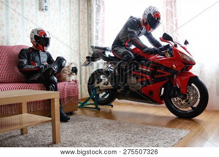Krasnoyarsk, Russia - December 21, 2018: Beautiful Motorcyclist In Full Gear And Helmet On A Red And