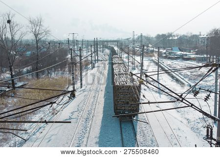 Rail Cars Loaded With The Wood Being Transported From Nearby Mines To Power Plants In Winter
