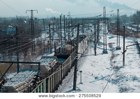 Rail Cars Loaded With The Wood Being Transported From Nearby Mines To Power Plants In Winter