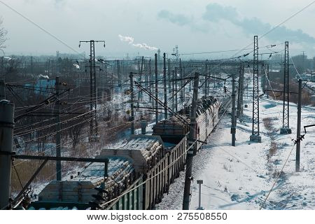 Rail Cars Loaded With The Wood Being Transported From Nearby Mines To Power Plants In Winter