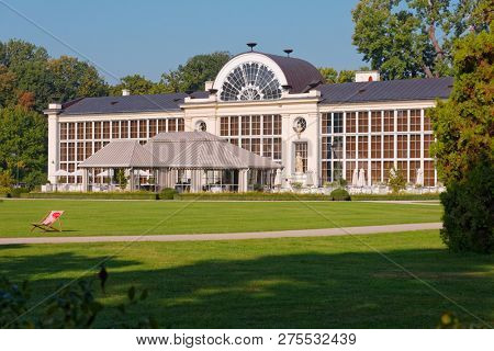 WARSAW, POLAND - SEPTEMBER 21, 2018: People resting at New Orangery in Lazienki Krolewskie park. Built in 1861 for the orange trees, it now houses the restaurant
