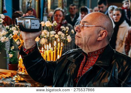 Voyutyn, Ukraine - 14 October 2008: Man Filmed On Video Camera Ceremony At Church
