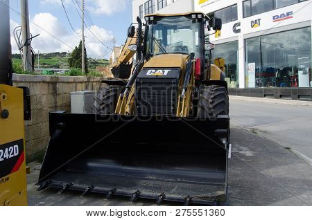 Burmarrad, Malta, 15 December 2018 - Small Lifter Yellow Excavator In The Machinery Store