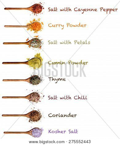 Collection Of Various Colorful Spices With Inscription In Wooden Spoons: Dried Paprika, Curry Powder