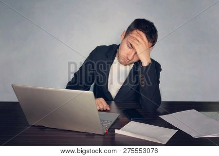 A Person Works At A Computer In The Office And Is Experiencing Fatigue And Fatigue. Office Worker Ho