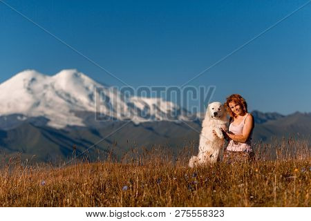 Beautiful Women And White Dog Morema Sit On Grass In Mountain