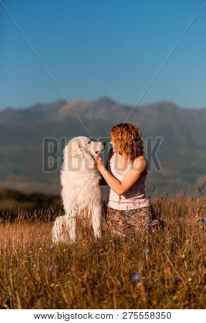 Beautiful Portrait Women And Cool White Dog Morema Sit On Grass In Mountain