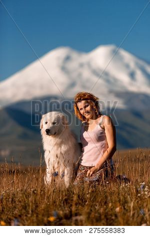 Beautiful Portrait Women And Cool White Dog Morema Sit On Grass In Mountain