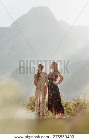 Two Amaizing Sexy Young Girl Stay In Field In Mountain Smiling